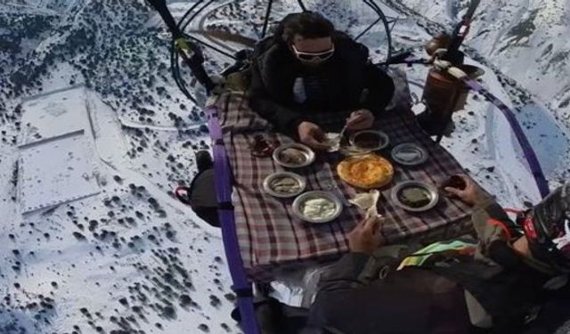 İki paraşütçü gökyüzünde kahvaltı masası kurdu